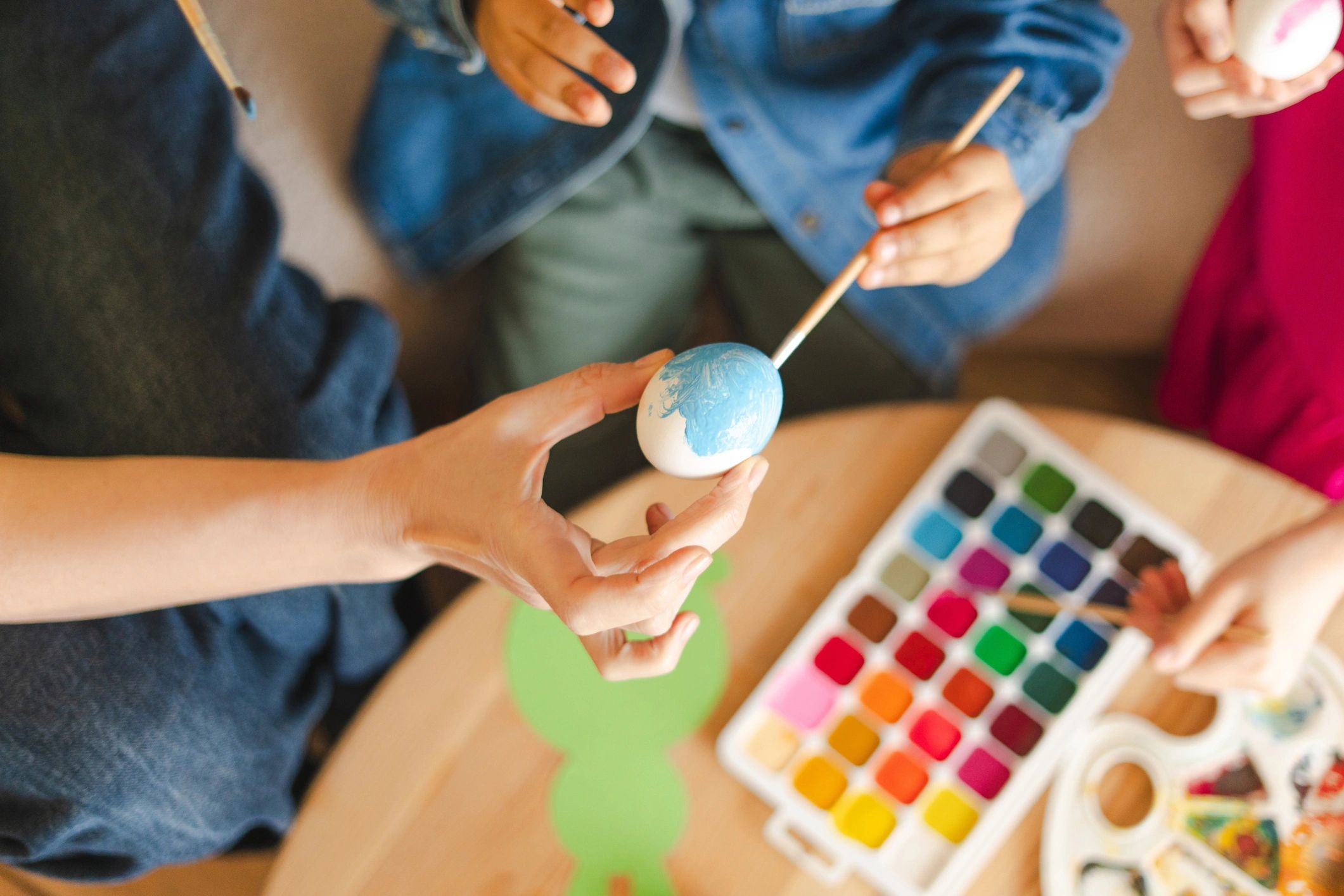 Hands painting a colorful craft project