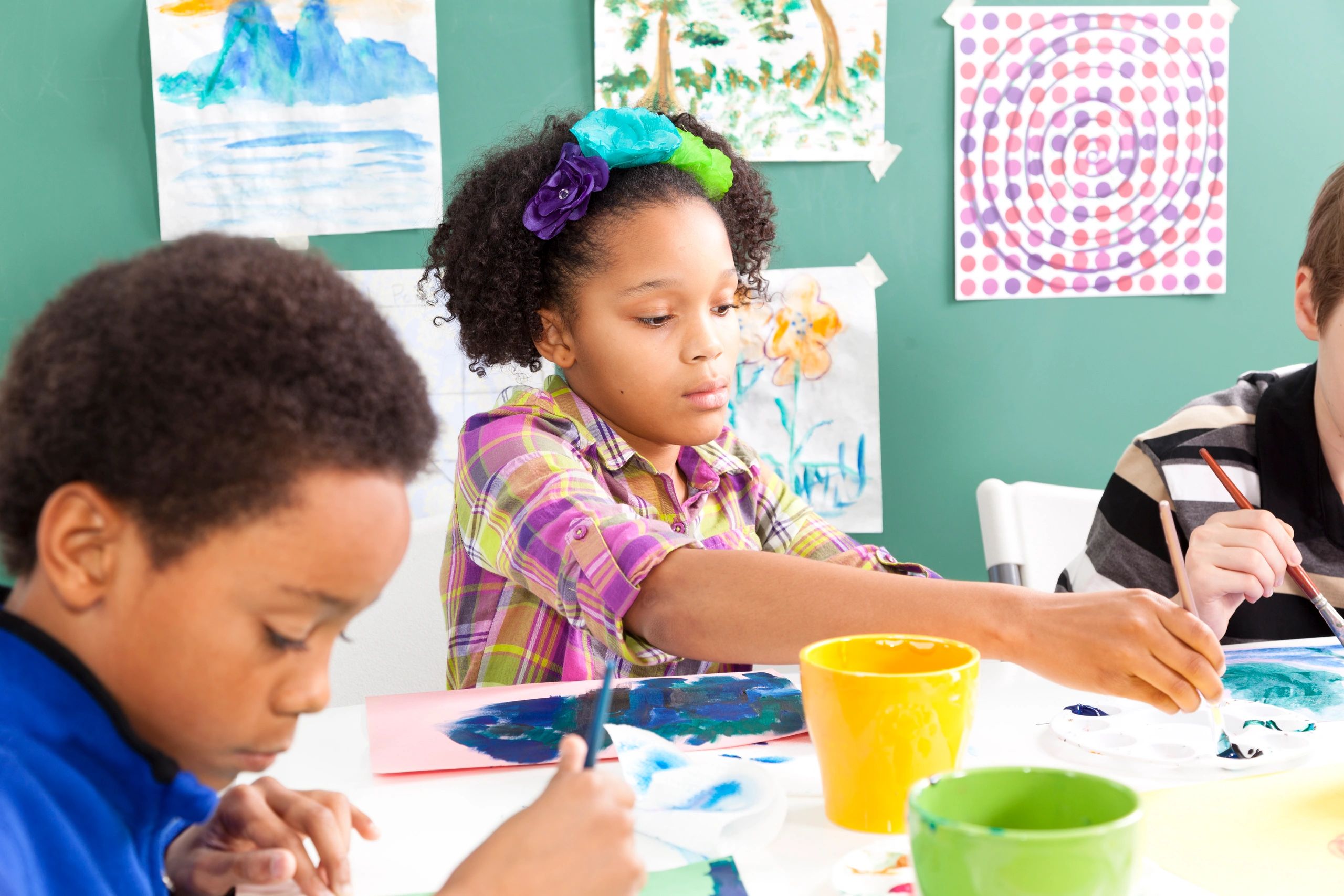 Children painting with watercolors in an art class