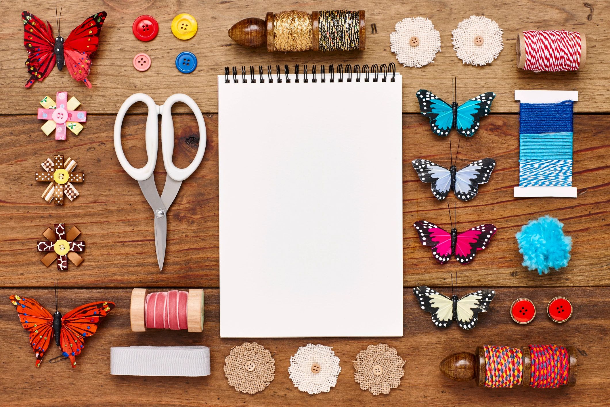 Flat lay of colorful craft supplies and notebook